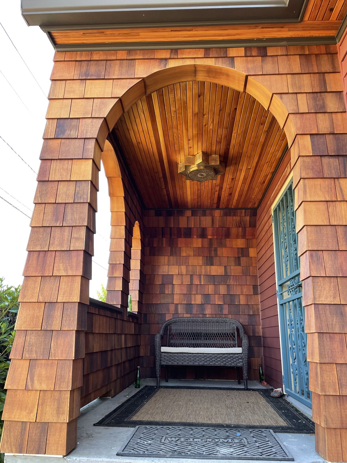 Arched cedar shingle entry porch