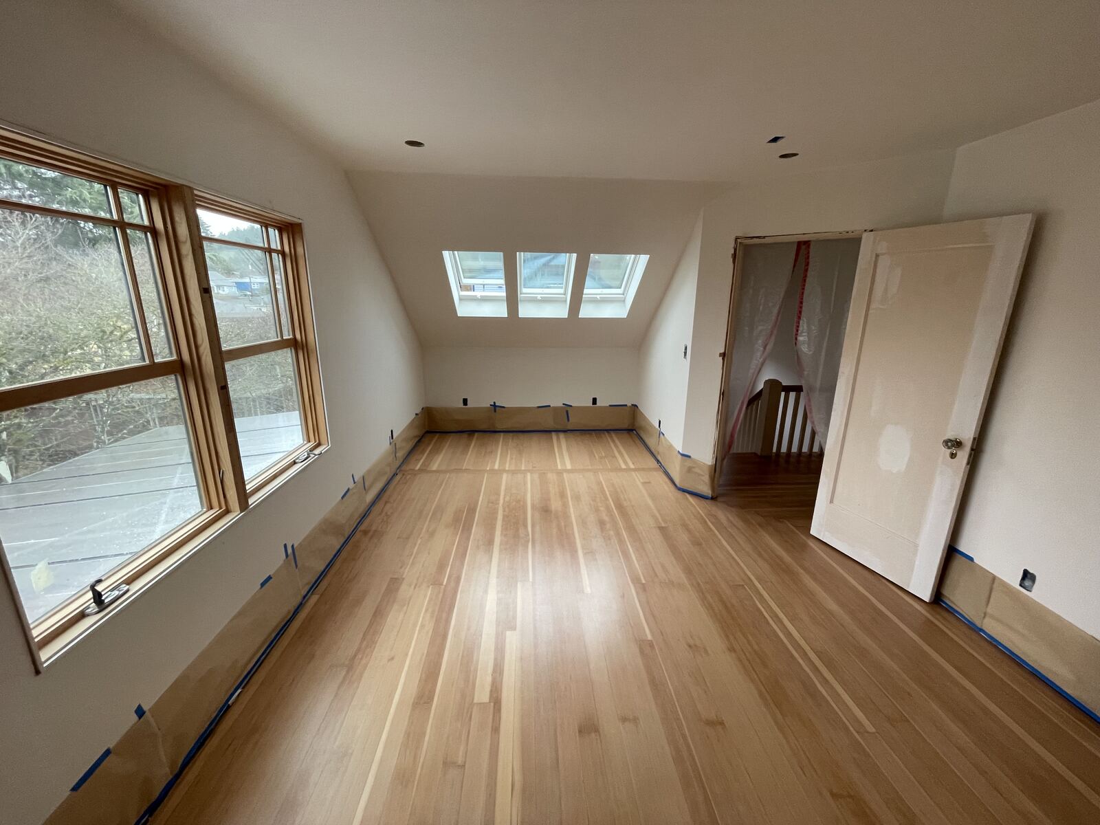 Finished attic loft with hardwood flooring