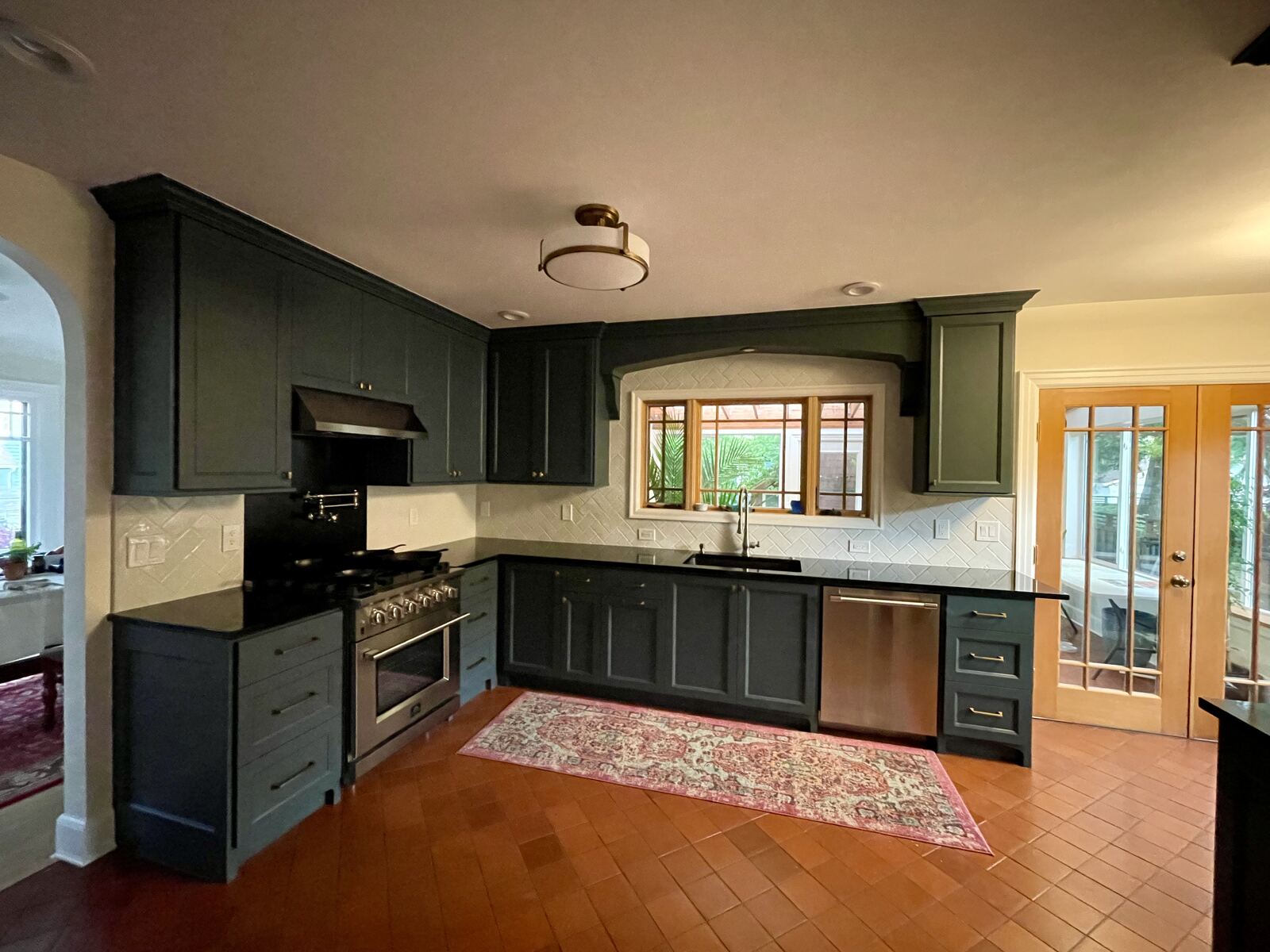 Renovated kitchen with green cabinets